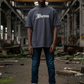 J/bronw Signature Tee — Navy — worn by a model, front view